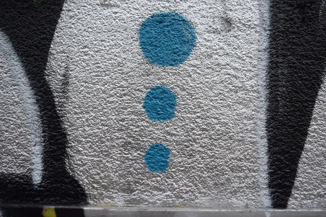 Three blue dots on a textured surface