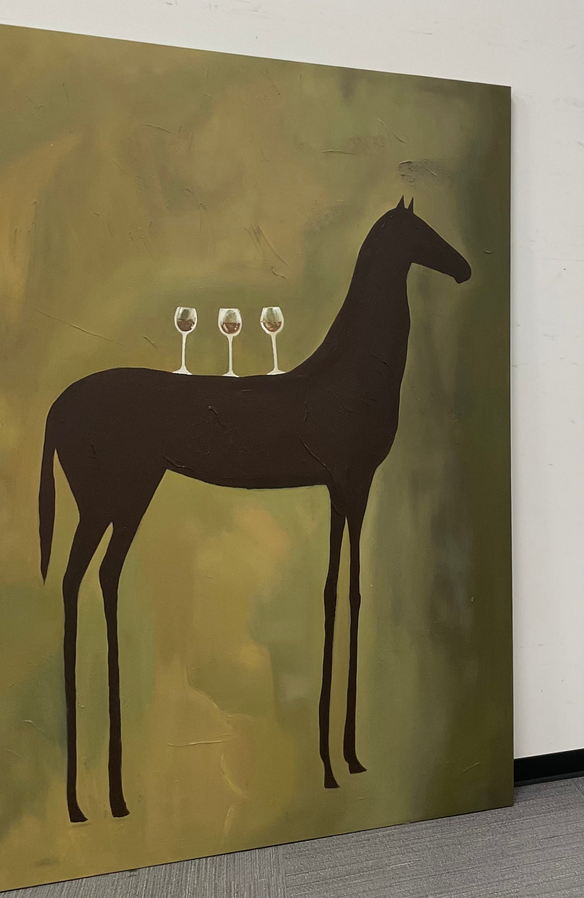 Large textured green horse plaster painting creating a warm focal point above an entryway console table.