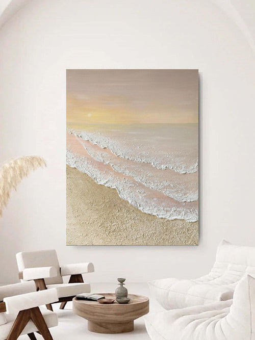 Heavy textured sunset beach canvas artwork styled above a neutral beige sofa in a bright modern living room