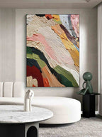 Abstract colorful wall art displayed above sofa in modern living room interior design