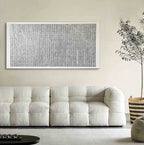 Restful neutral 3D plasterwork introducing a layer of understated elegance above an airy master bedroom bed setup.