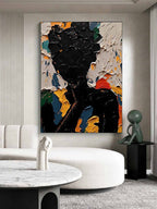 Bold abstract dark silhouette canvas artwork beautifully framed and hung in a modern dramatic living room.
