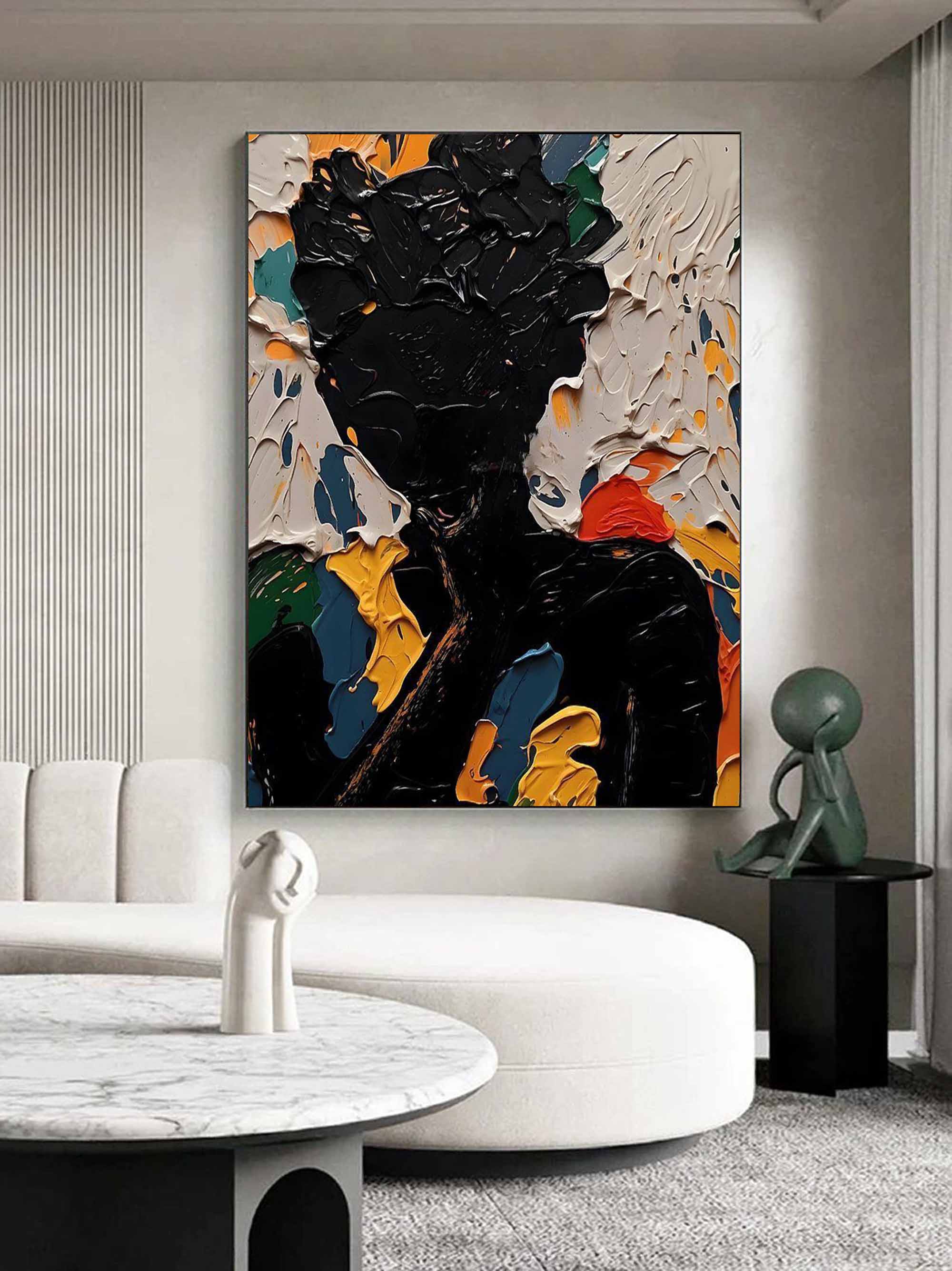 Bold abstract dark silhouette canvas artwork beautifully framed and hung in a modern dramatic living room.