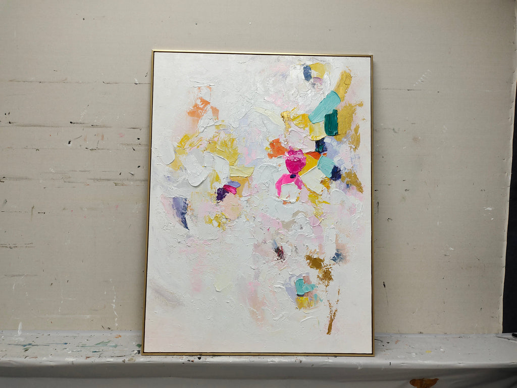 Colorful modern textured artwork mounted in a minimalist home office studio with natural gallery-style lighting setup