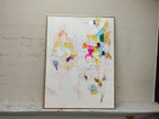 Colorful modern textured artwork mounted in a minimalist home office studio with natural gallery-style lighting setup