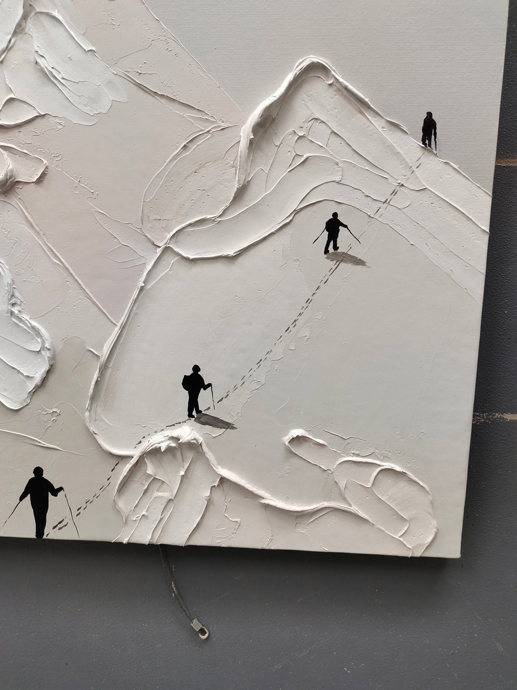 Close-up macro detail of heavy texture plaster artwork showing exquisite palette knife snow ridges and tiny climbers