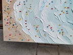 Close-up macro detail of heavy texture plaster artwork showing exquisite palette knife white waves and colorful swimmers