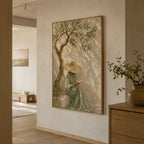 Mediterranean olive tree woman canvas painting displayed above a beige linen sectional sofa in a modern Wabi Sabi living room