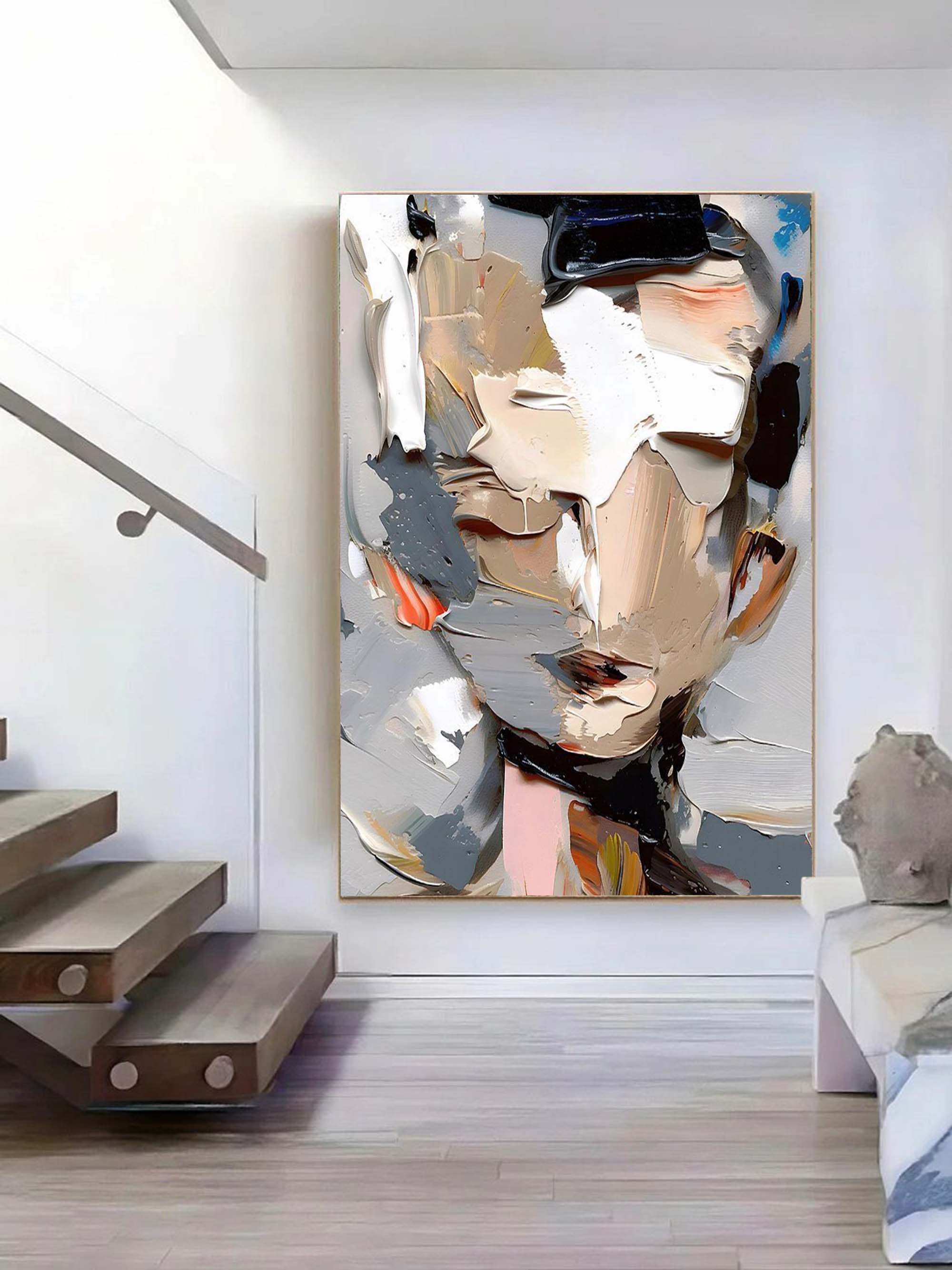 Modern heavy palette knife face wall art styled above a contemporary minimalist sofa in a luxury living room