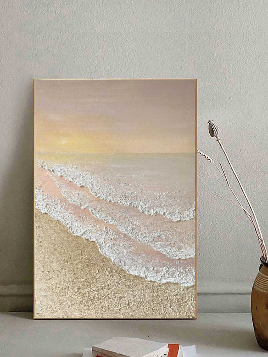 Minimalist pastel beach textured artwork mounted above a console table in an entryway with soft gallery-style lighting