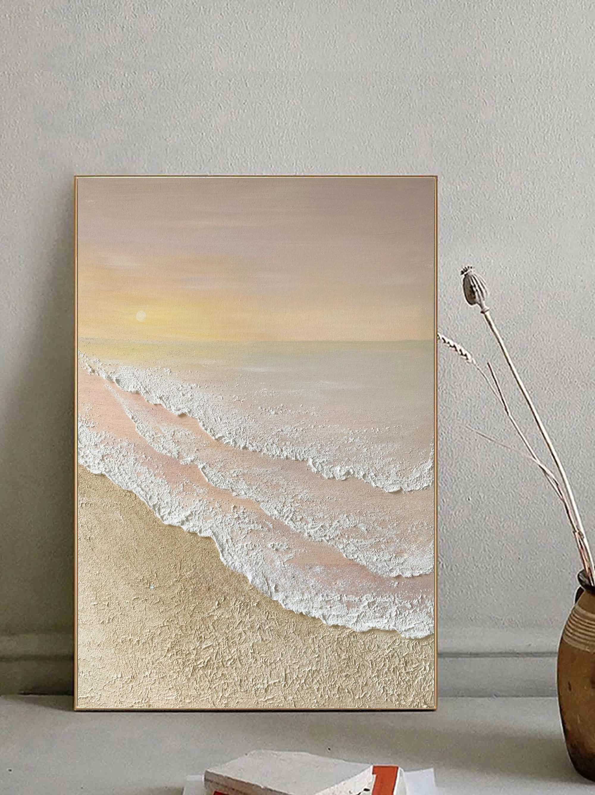 Minimalist pastel beach textured artwork mounted above a console table in an entryway with soft gallery-style lighting
