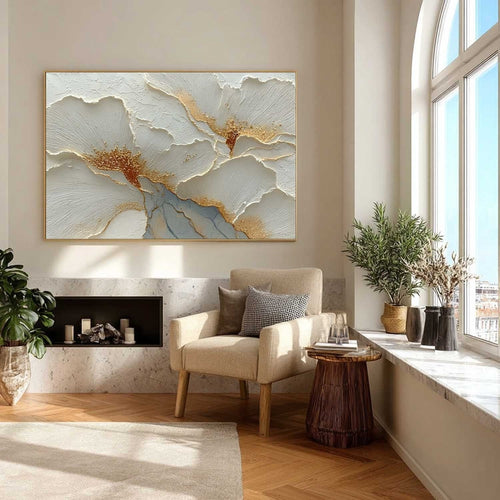 Large white textured flower canvas painting hanging above a minimalist sofa in a modern living room