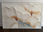 Golden floral textured wall art hanging in the entryway
