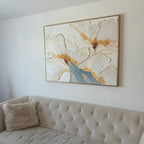 A floral plaster wall art painting hangs above the sofa in the living room.