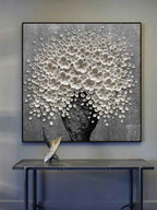 Modern white flower metallic canvas painting styled above a neutral fabric sofa in a luxury living room