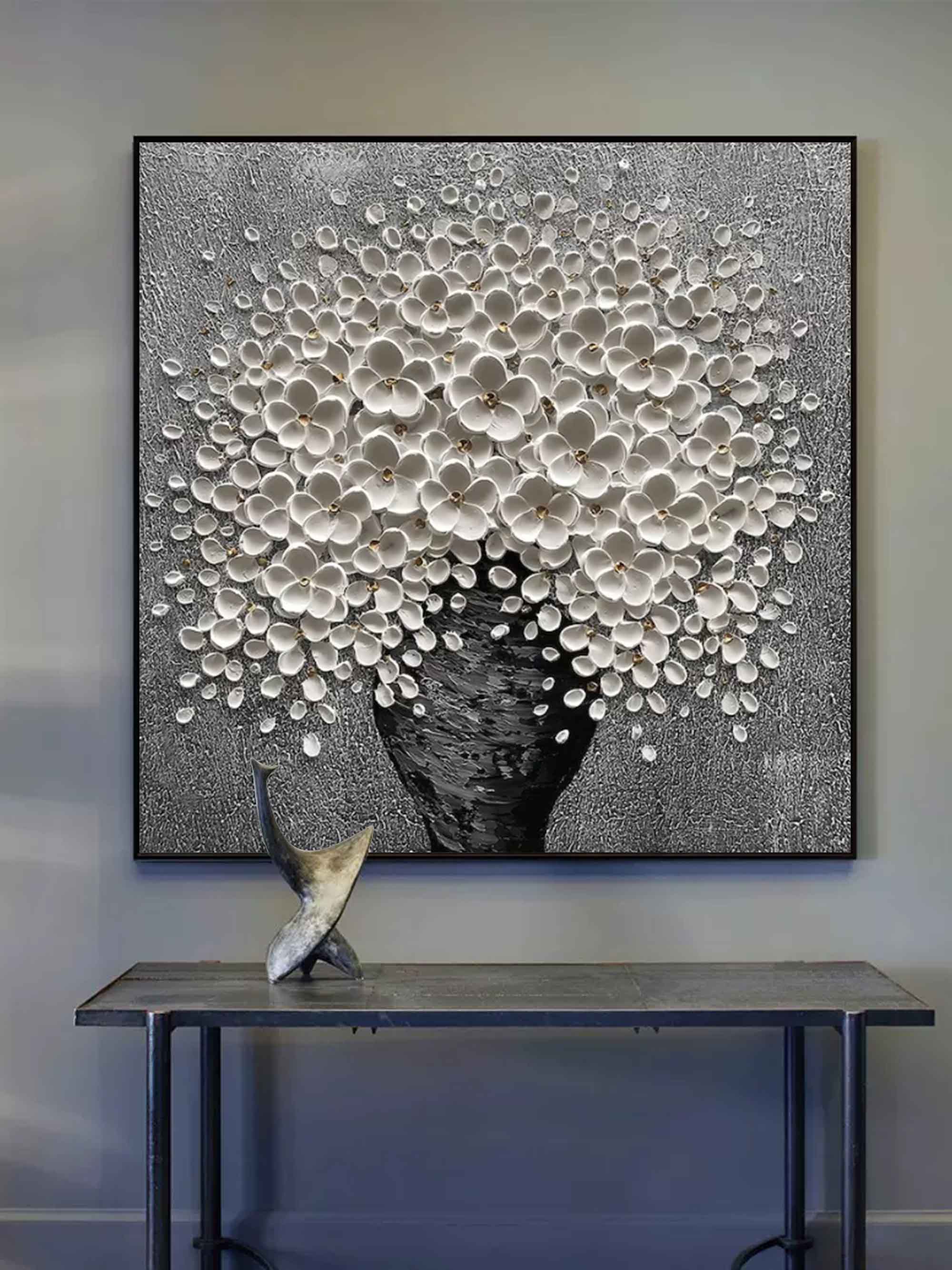 Modern white flower metallic canvas painting styled above a neutral fabric sofa in a luxury living room