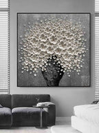 Large vertical 3D impasto white blossoms artwork hanging on a contemporary entryway gallery wall
