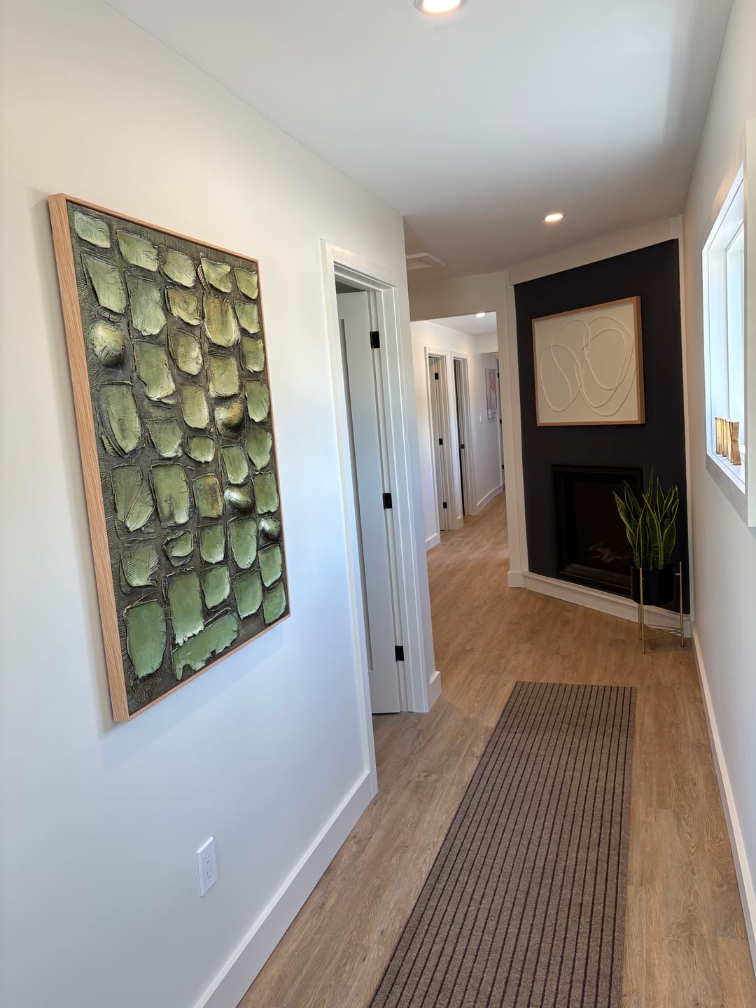 Sophisticated heavy textured abstract foliage artwork adding biophilic design and cozy style to a home hallway.