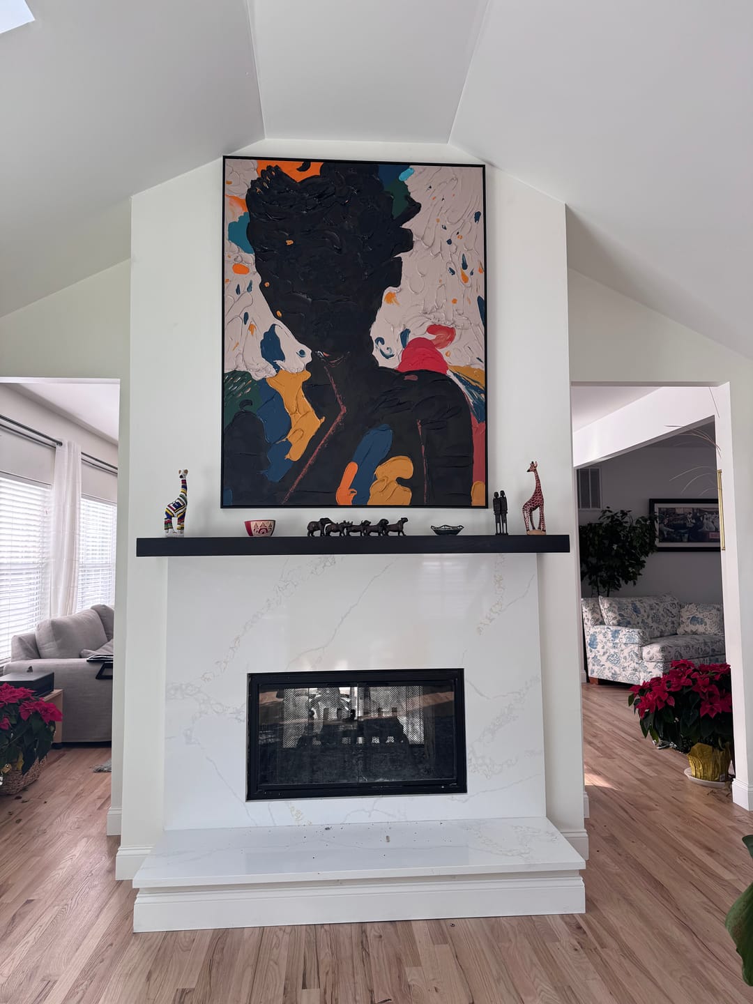 Contemporary thick texture black figure art piece enhancing the gallery wall of a luxury dining room area.