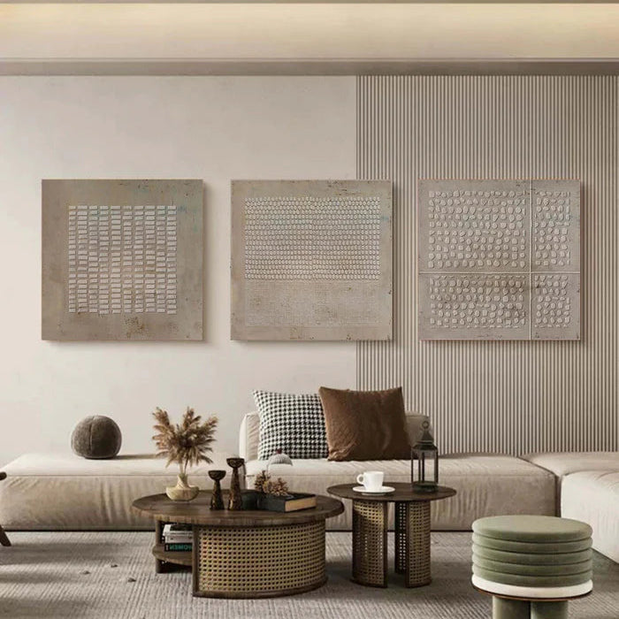 Set of 3 abstract wabi-sabi wall art panels displayed in modern living room above neutral sofa