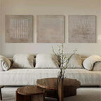 Abstract textured panel art set styled in modern luxury living room with stone and wood accents