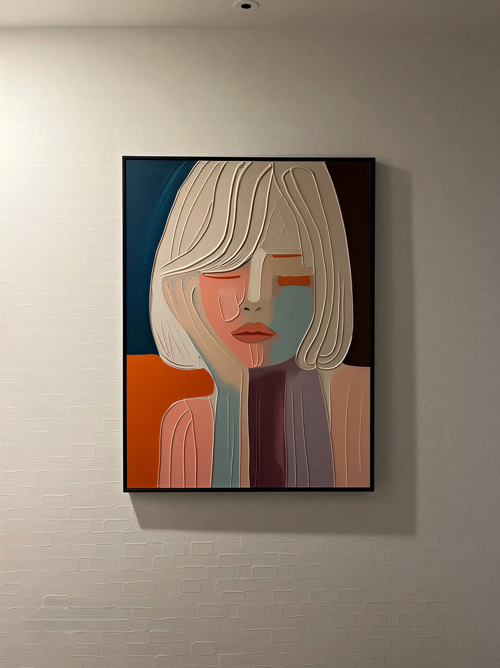 A framed abstract portrait painting of a woman with stylized geometric shapes in orange, blue, beige, and purple, hanging on a living room wall.