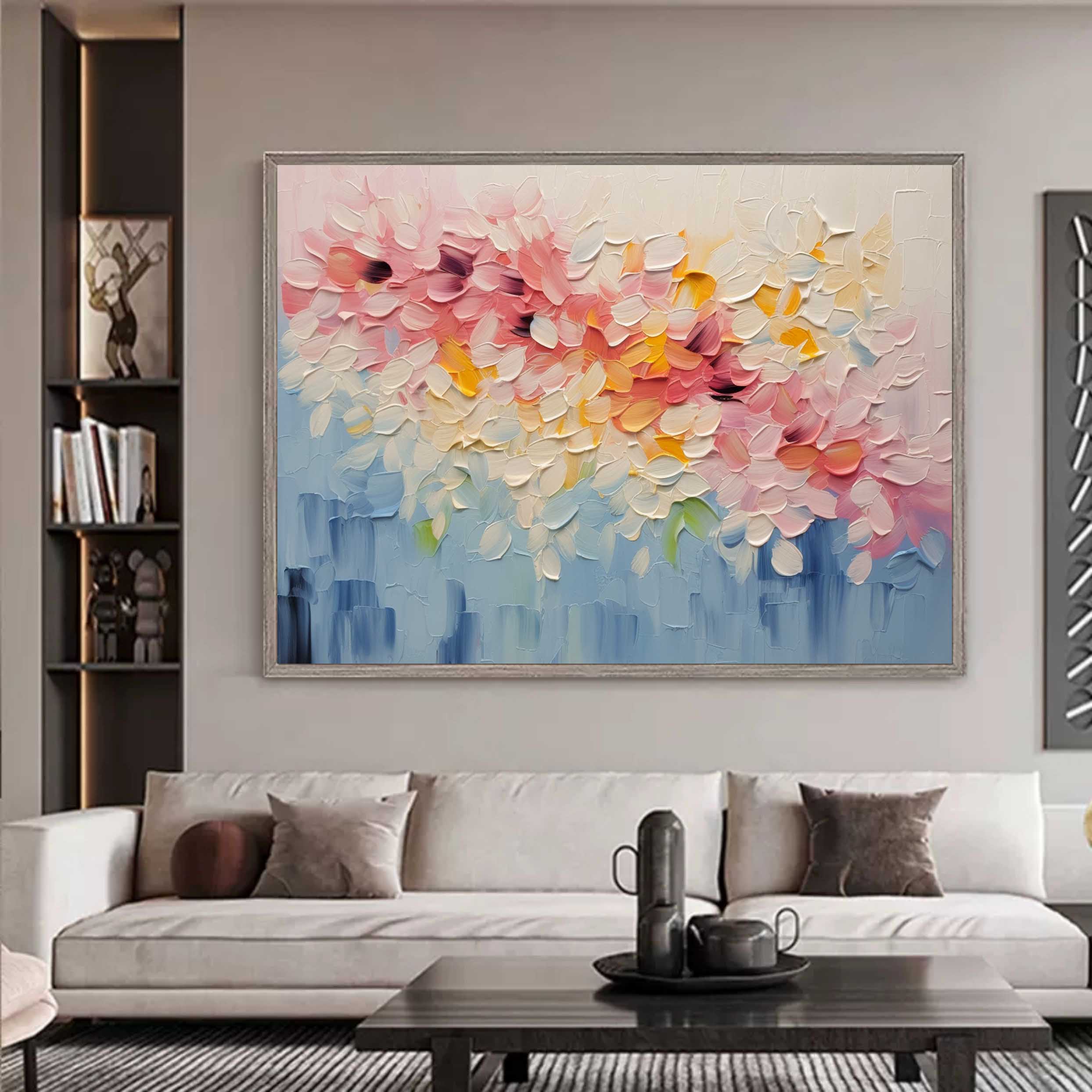 Large colorful abstract flower canvas painting beautifully framed and hung perfectly above a living room sofa.