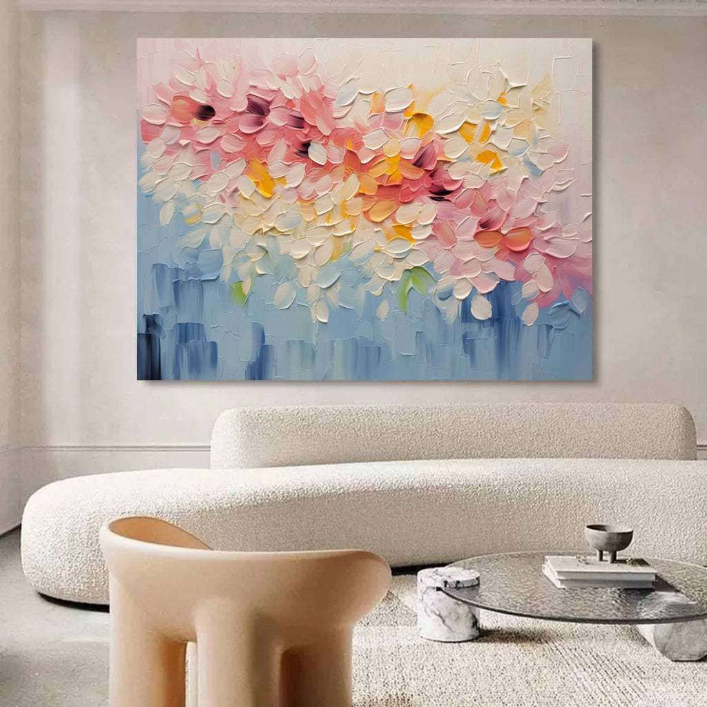 Modern heavy texture romantic blossom artwork creating a cheerful focal point over a master bedroom bed setup.