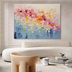 Modern heavy texture romantic blossom artwork creating a cheerful focal point over a master bedroom bed setup.