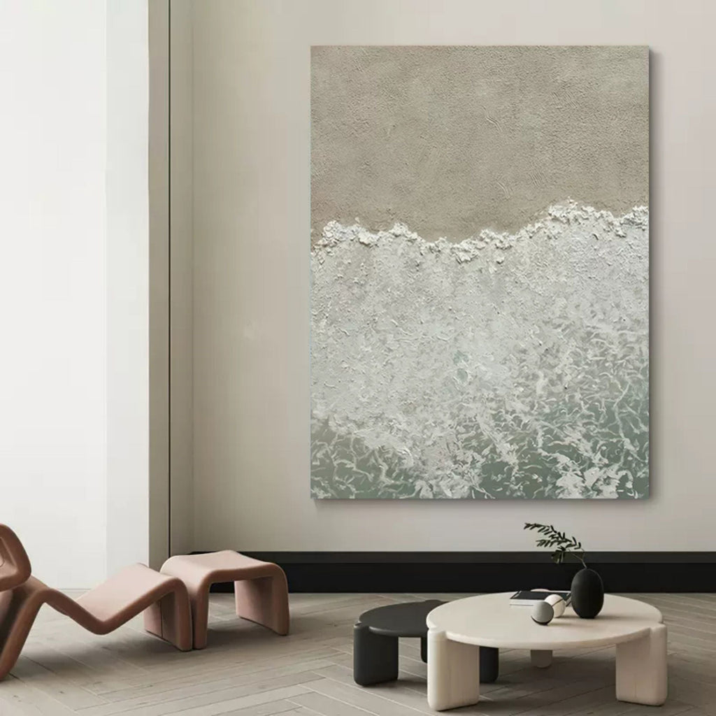Large coastal style abstract sea wave canvas artwork beautifully framed and hung above a modern living room sofa.