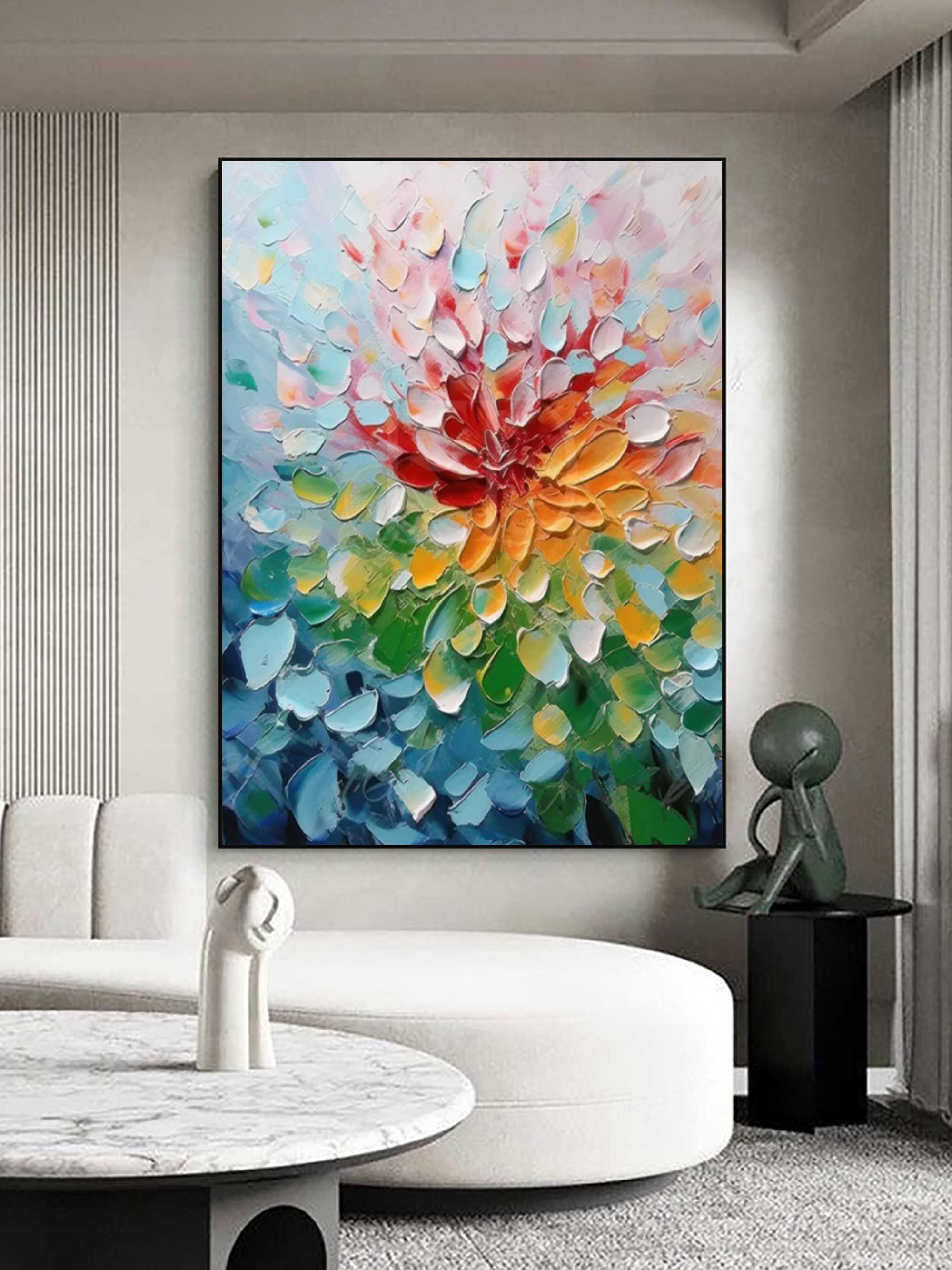 Heavy textured colorful abstract floral canvas artwork styled above a neutral linen sofa in a bright modern living room