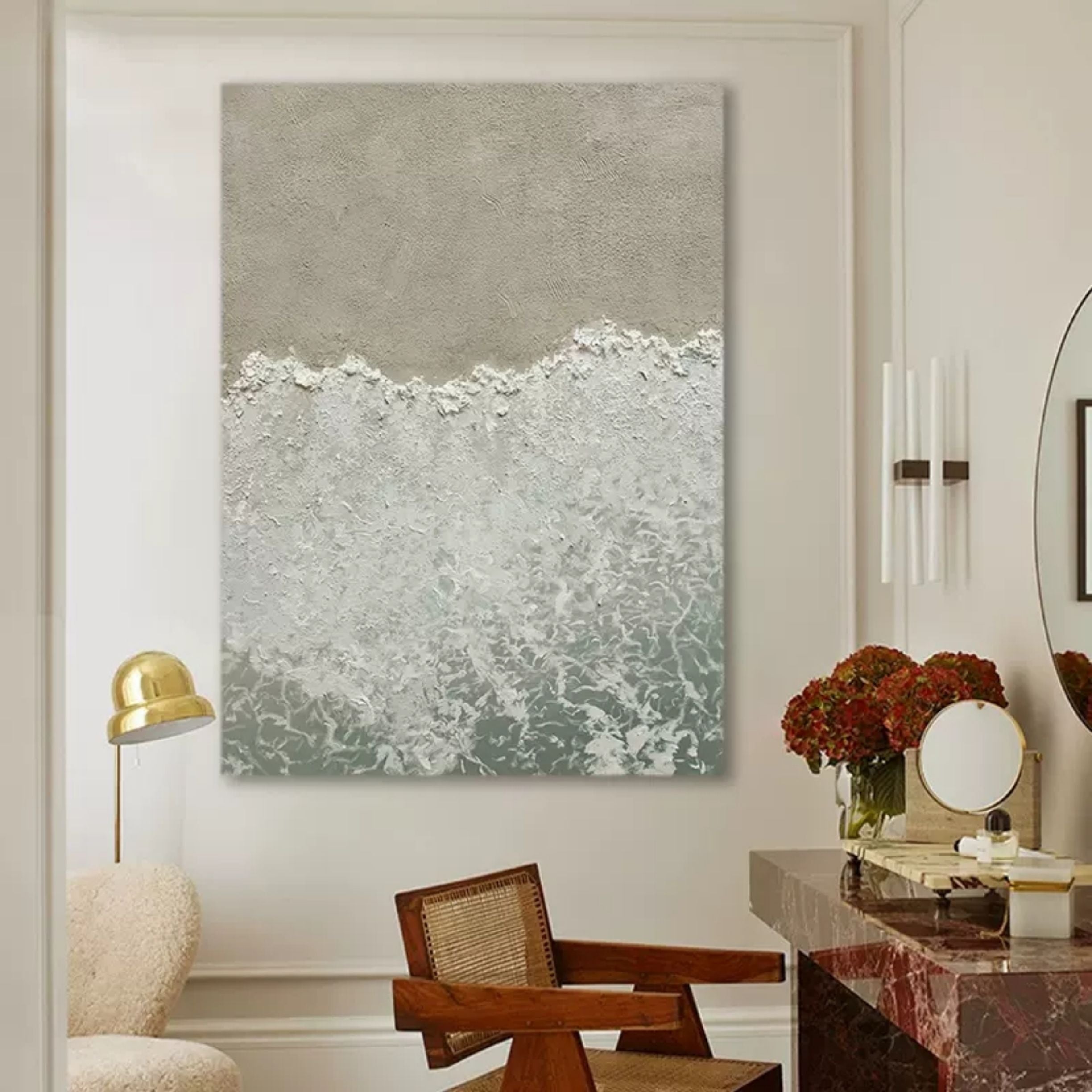 Modern neutral beach sand and ocean painting creating a serene coastal aesthetic over a master bedroom bed.