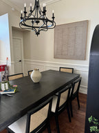 A large, beige wabi-sabi minimalist framed painting perfectly decorates a modern dining room.