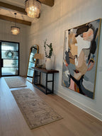 Abstract portrait textured wall art hangs in the entryway