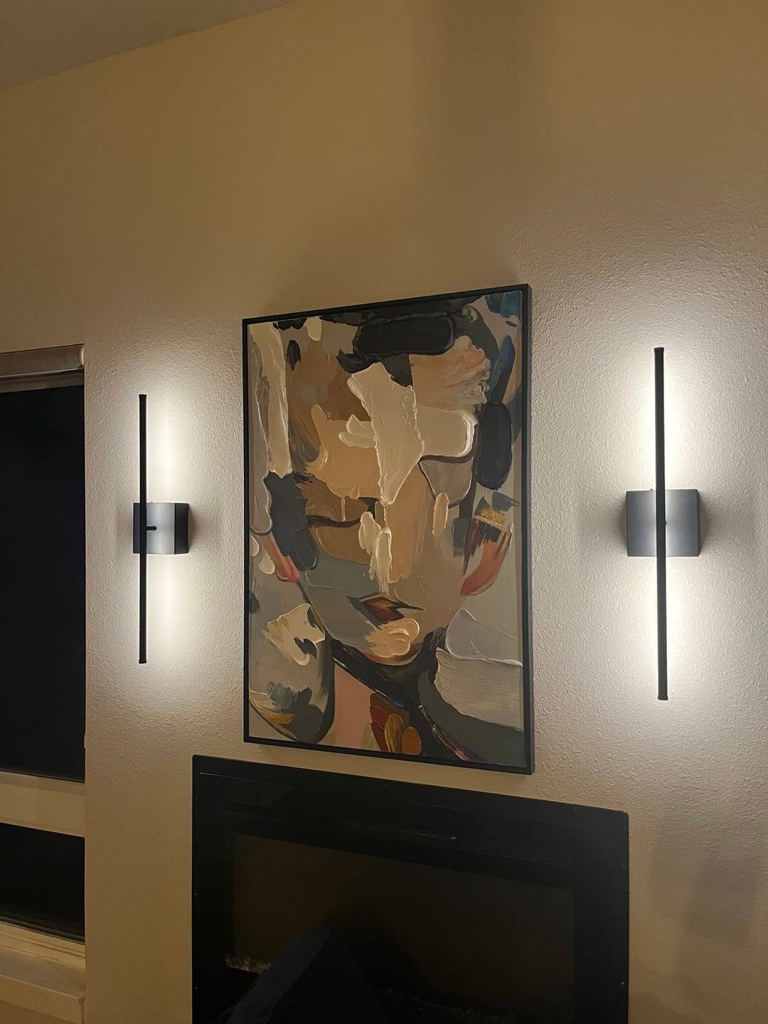 Abstract people textured wall art hangs in the living room.