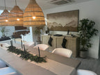 A large panoramic wabi-sabi beach abstract wall art perfectly decorates the dining room wall.