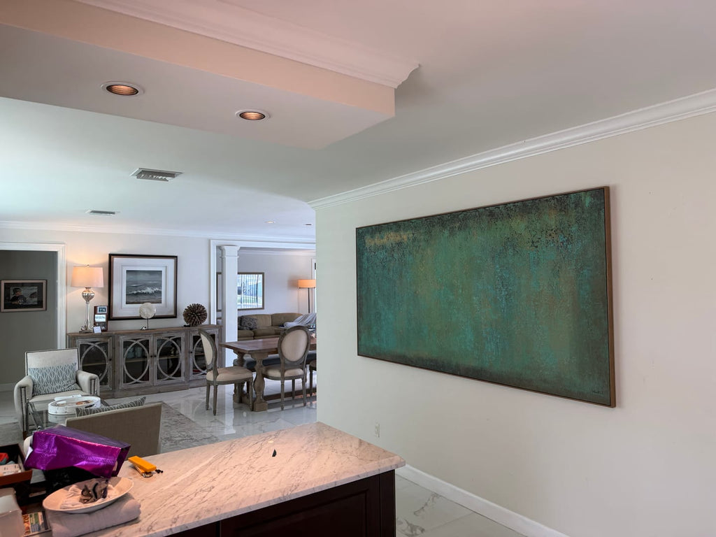 A large green Wabi-Sabi textured horizontal wall painting hangs on the restaurant wall.