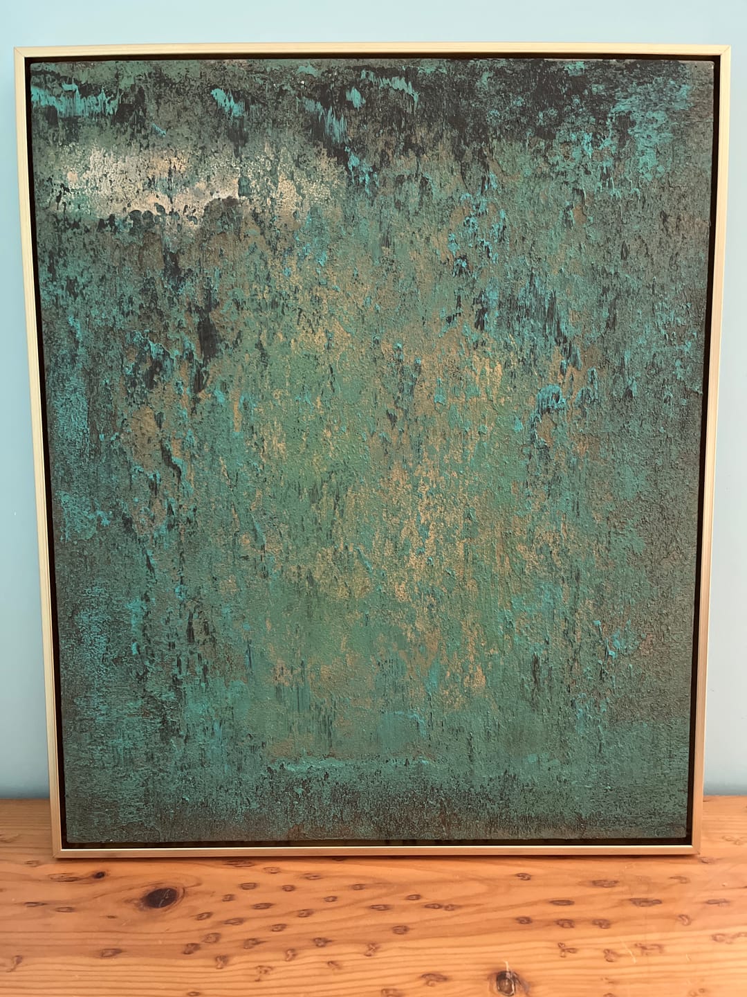 A green Wabi-Sabi wall art piece hangs in the living room.