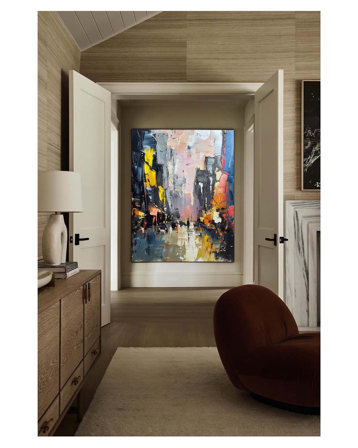 Avenue multi-colored heavy texture plaster relief painting beautifully displayed in an upscale dining space near the table