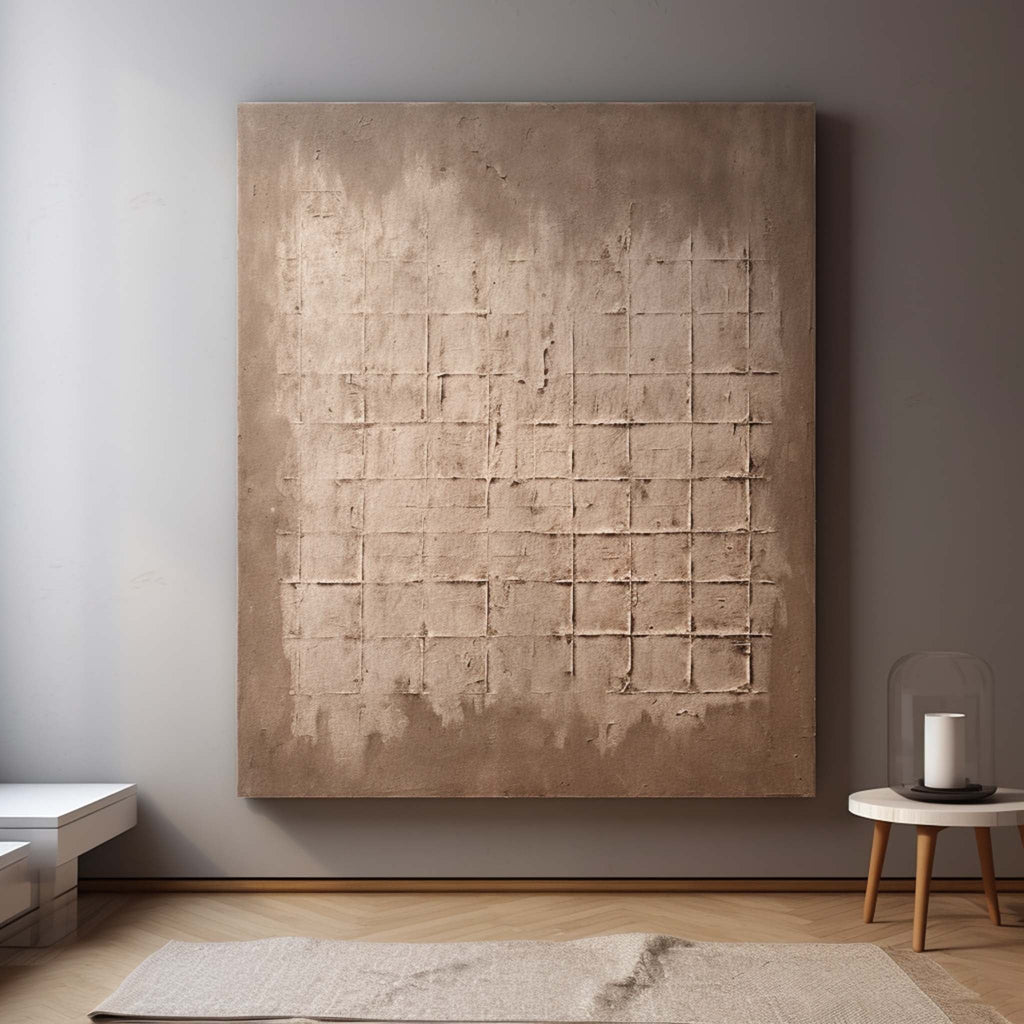 Large neutral abstract geometric painting beautifully framed and hung perfectly above a large living room sofa.