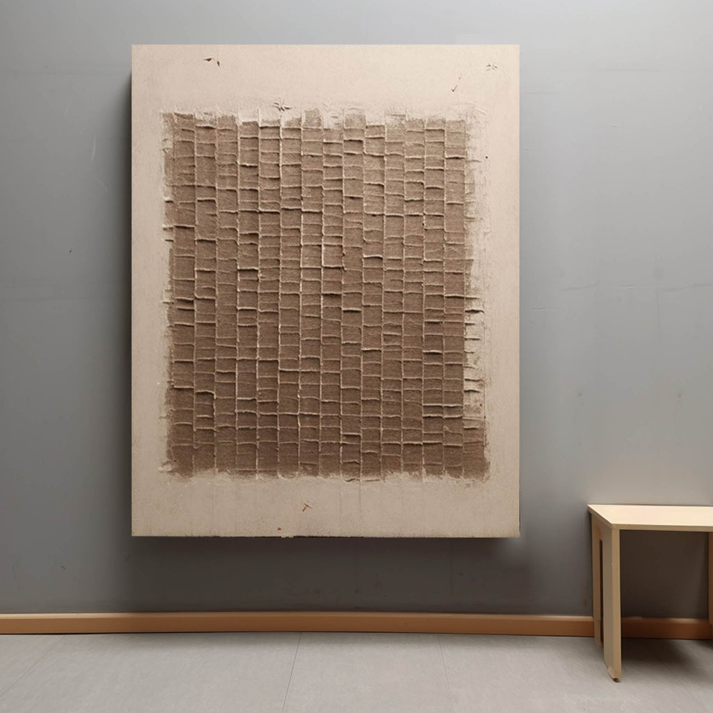 Large minimalist neutral grid canvas artwork beautifully framed and hung above a modern rustic living room sofa.
