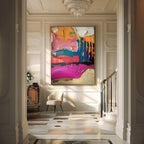 Large abstract colorblock canvas painting perfectly styled above a comfortable sofa in a sunlit modern living room