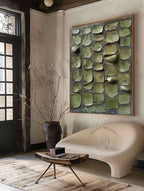 Large minimalist neutral botanical canvas artwork beautifully framed and hung above a rustic living room sofa.