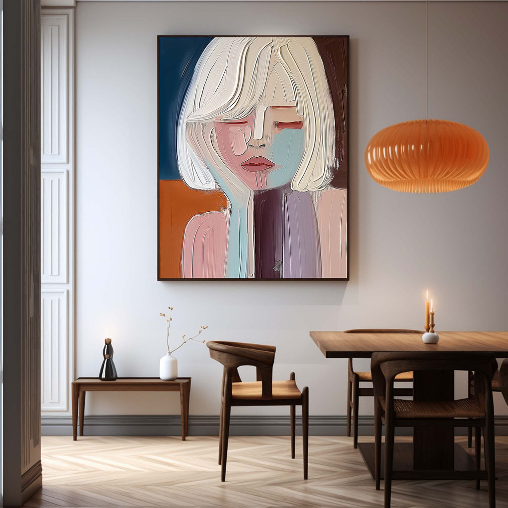 Modern abstract face wall art styled above a contemporary minimalist sofa in a luxury living room