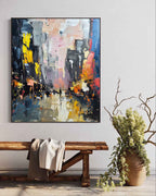 Large abstract cityscape canvas painting perfectly styled above a comfortable sofa in a sunlit modern living room